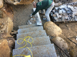 Man working on installing Antika pavers
