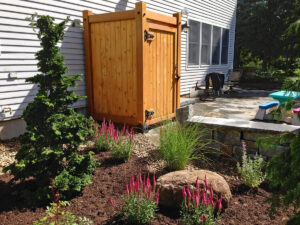 Custom-built cedar shower in backyard